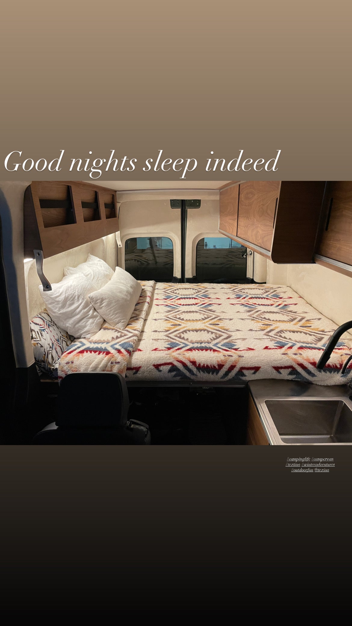 Cozy RV rental interior with a comfy bed, sink, & wood cabinets. Perfect for restful van life adventures!