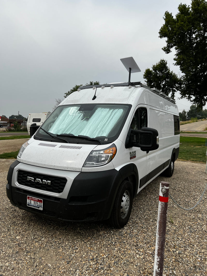 White Ram ProMaster van, an RV rental with Starlink for connectivity. Parked on gravel, ready for travel. — photo 3