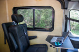 This RV rental offers a comfortable mobile office setup with a window view of nature. Perfect for remote work while traveling!