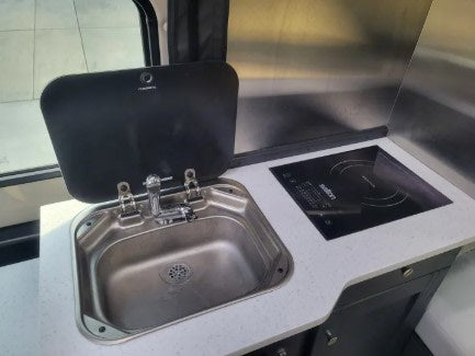  and a compact kitchenette setup.|Enjoy this bright RV rental with comfortable light gray seating — photo 18