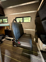 RV rental: Inside, a black leather bench seat, ICECO portable fridge, and custom interior.
