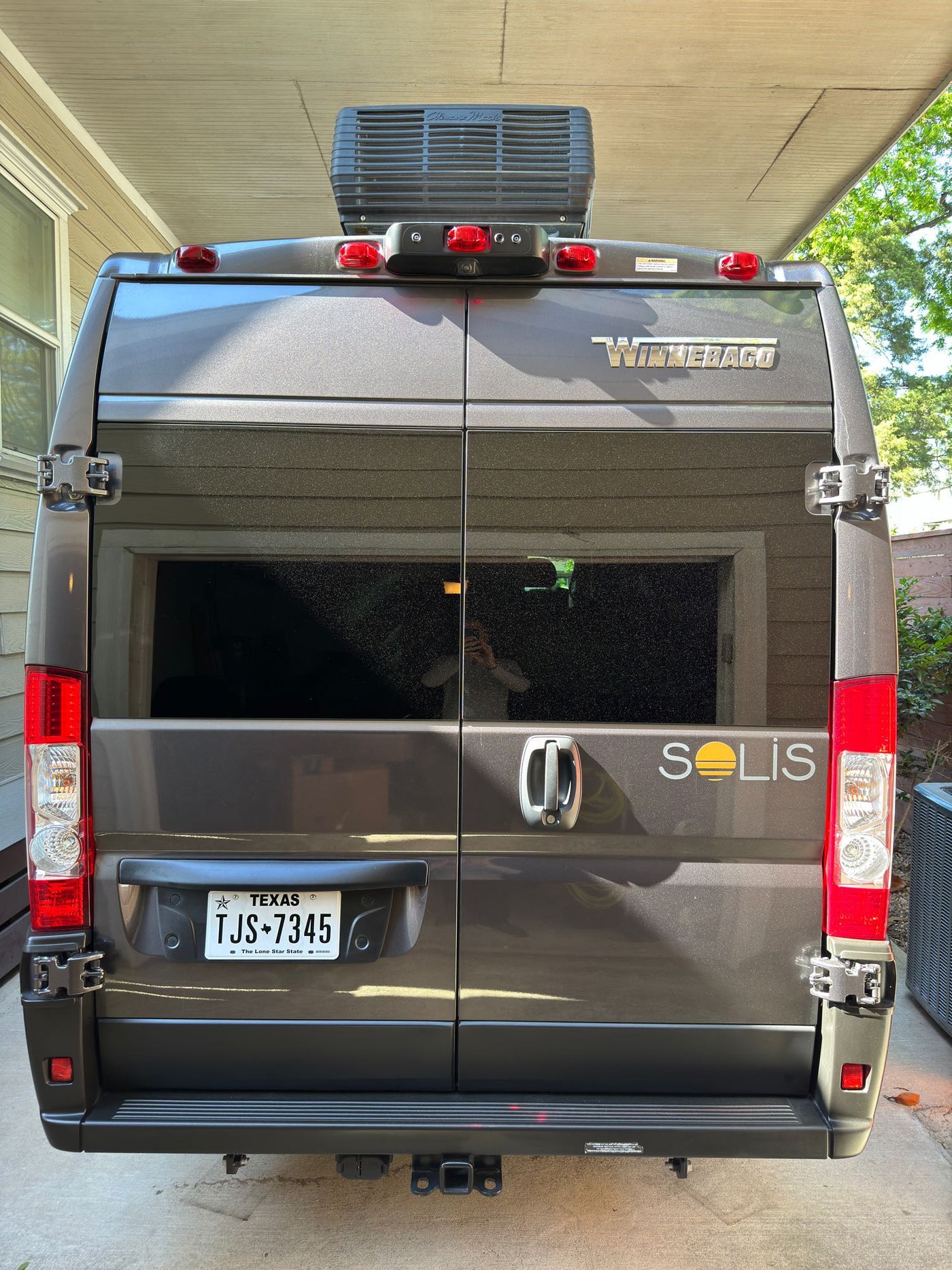  parked under a carport.|Inside an RV rental — photo 7