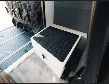 Practical RV rental interior features durable floor mats, a versatile storage step, and a door organizer for efficient space.