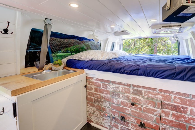  and personalized decor.|This rv rental camper van is set up for a comfortable outdoor experience with an awning — photo 2