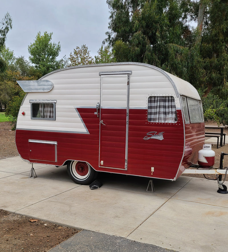 This vintage red and white Shasta travel trailer could be a unique rv rental for your next adventure. — photo 1