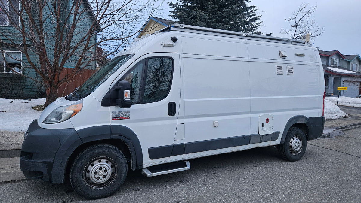 Customized white Ram ProMaster camper van parked on a snowy street, ready for your rv rental adventure. — photo 14