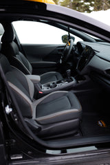 Modern vehicle interior: two-tone seats, tech display, and shifter. Ready for snowy roads and your RV rental adventure.