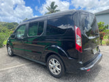 Black Ford Transit Connect van with tinted windows, parked on concrete in Hawaii. Suitable for travel or RV rental.