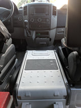 RV rental Mercedes Sprinter van interior: dashboard, steering wheel, and portable fridge between front seats.