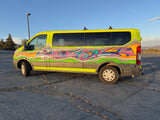 Vibrant lime-green graffiti RV rental van, ready for adventure, parked on cracked asphalt under a clear blue sky.