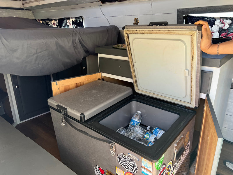  and open drawers revealing neatly organized cooking tools and supplies.|Cozy RV rental sleeping area with comfy bed — photo 13