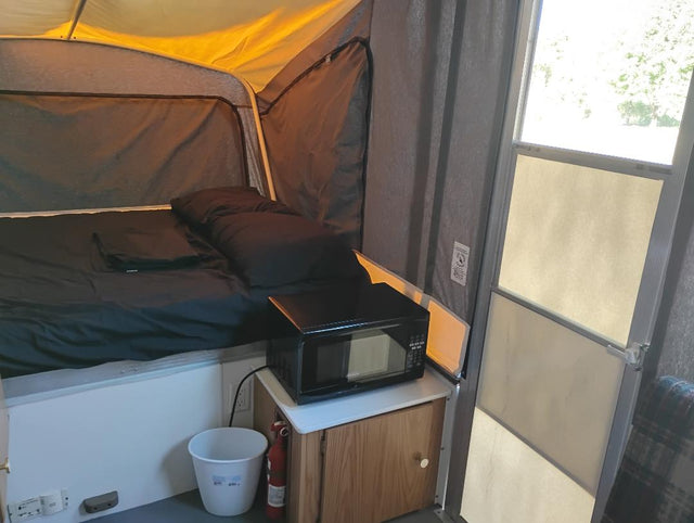  and a sink. Ready for your next camping adventure!|Inside an RV rental pop-up camper: a compact kitchenette with sink