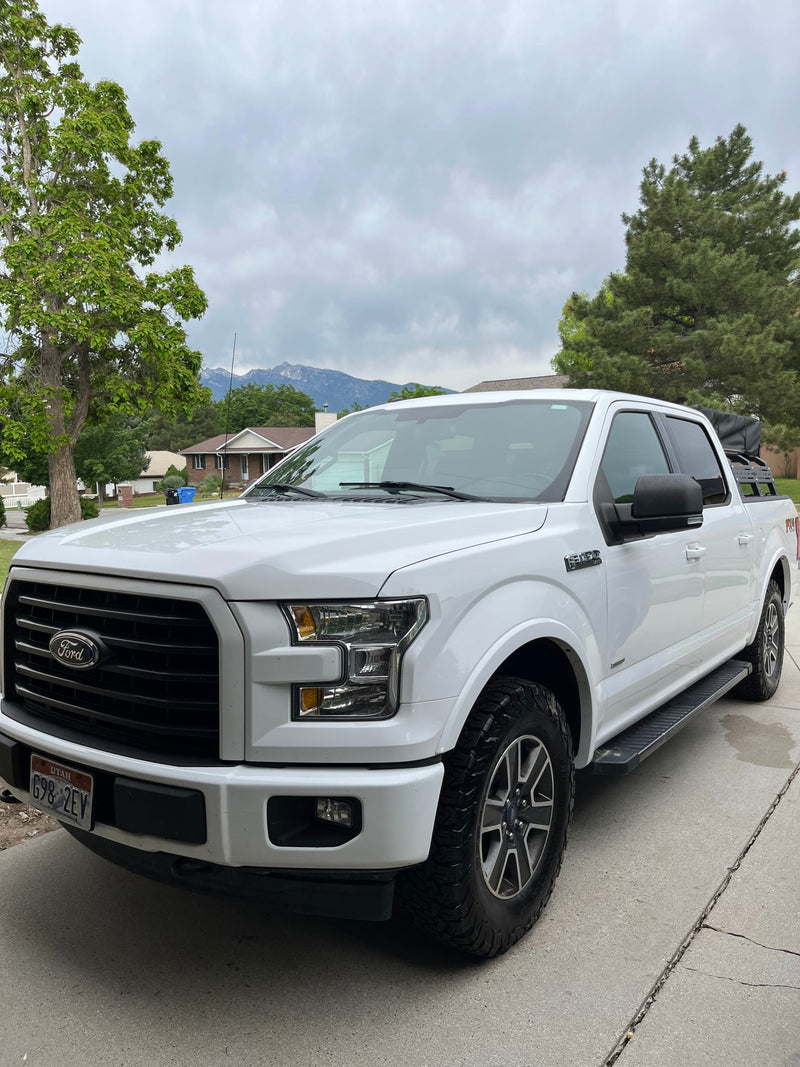 White Ford F-150 truck with rooftop tent for adventure travel. Consider an RV rental for your next outdoor trip. — photo 9