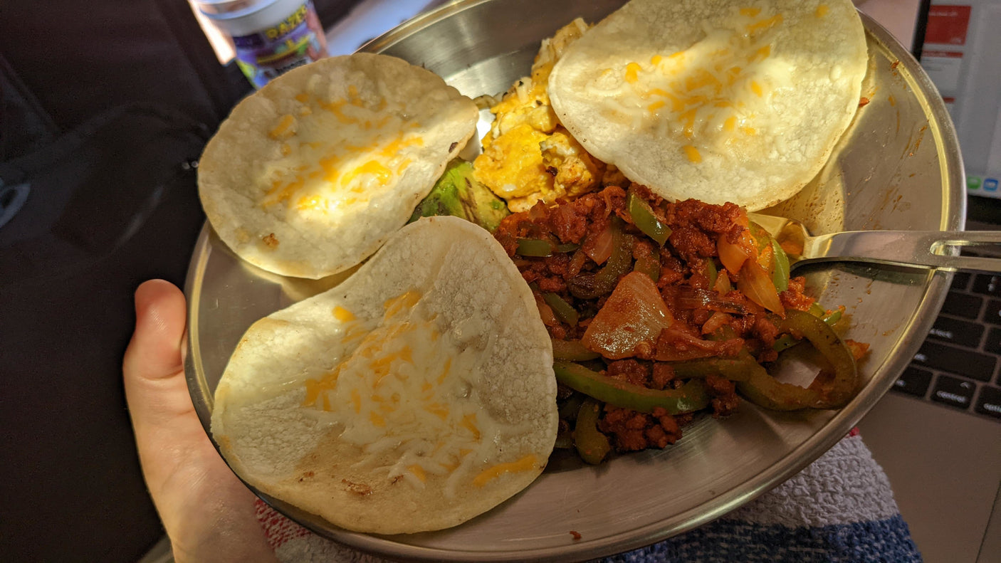 Hearty RV rental breakfast: Cheesy tortillas, eggs, chorizo, peppers, & avocado. Perfect for travel adventures!