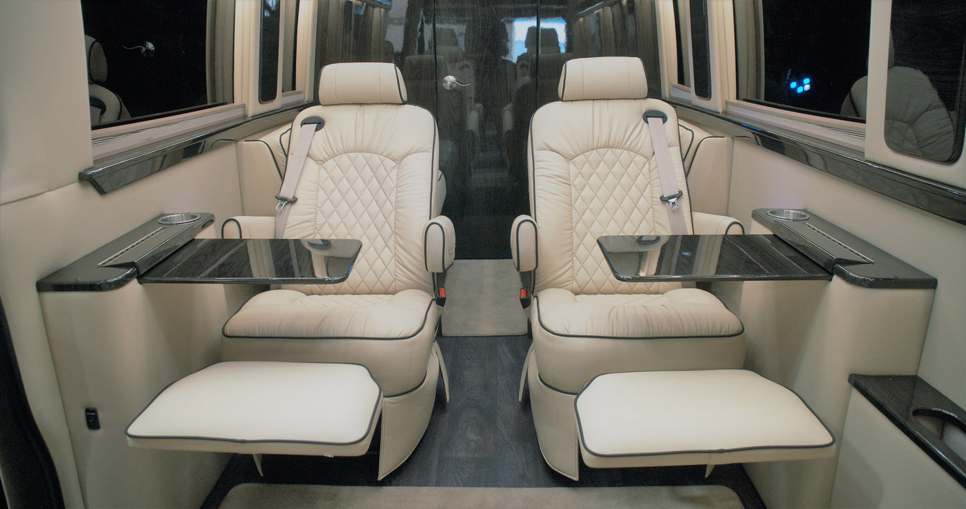  and kitchen unit with a fridge.|Experience comfort in a luxury RV rental. The spacious interior features cream quilted leather seats — photo 4