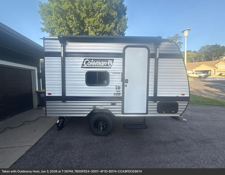  and toaster oven combo.|Cozy RV rental bedroom with a patchwork quilt