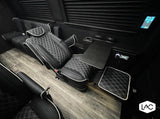 Experience premium comfort! This luxury RV rental interior features diamond-stitched seats, wood flooring, & a fold-out table.