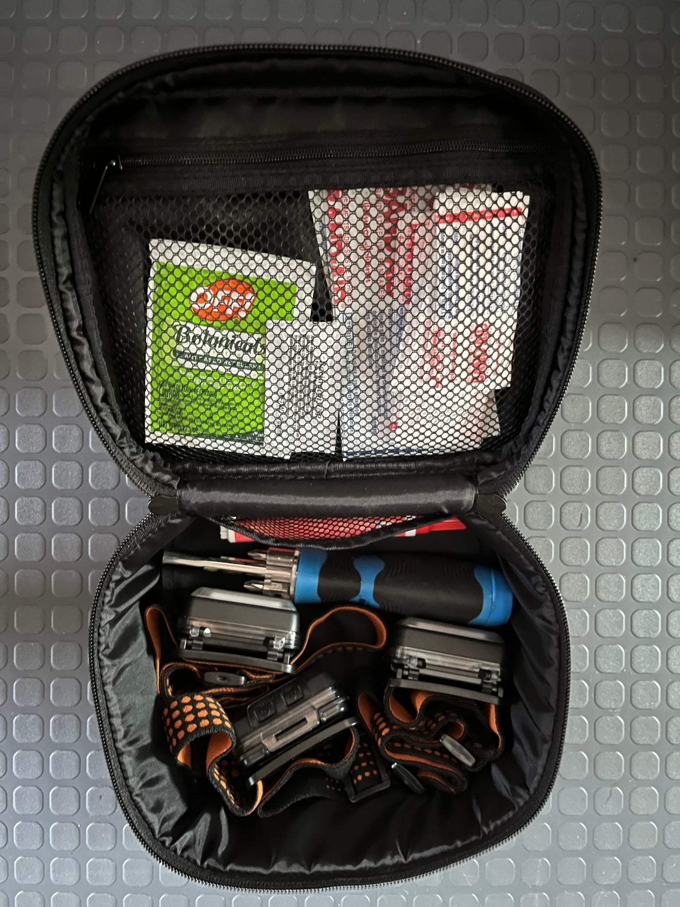 RV rental essentials: Open bag with headlamps, multi-bit screwdriver, and bug repellent packet. — photo 8