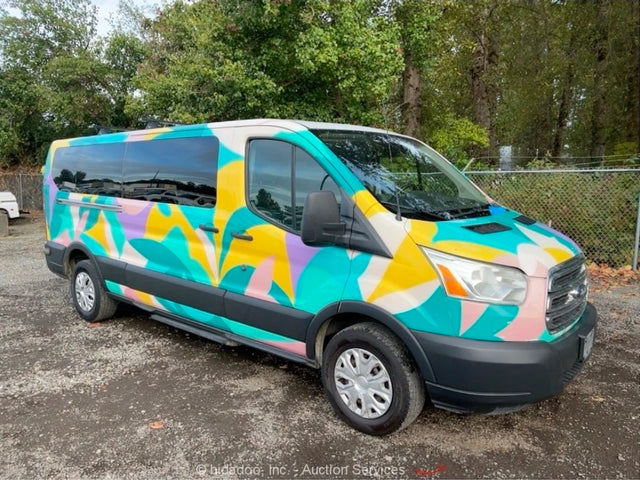  abstract-painted Ford Transit RV rental parked against a backdrop of mountains & tall trees under a bright blue sky.|Vibrant