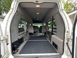 Spacious white van interior with gray seats & dark floor. Ideal for an rv rental, cargo, or passenger transport.