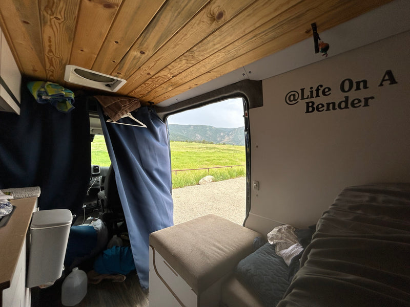 Enjoy the outdoors from this RV rental! Cozy camper van interior with wooden ceiling and scenic mountain view. — photo 4