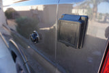 Close-up of a gray RV rental exterior: 30A shore power inlet and water fill point.