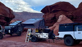 Overlanding RVs & rooftop tents camped in a red rock desert. Your next adventure awaits with an RV rental!