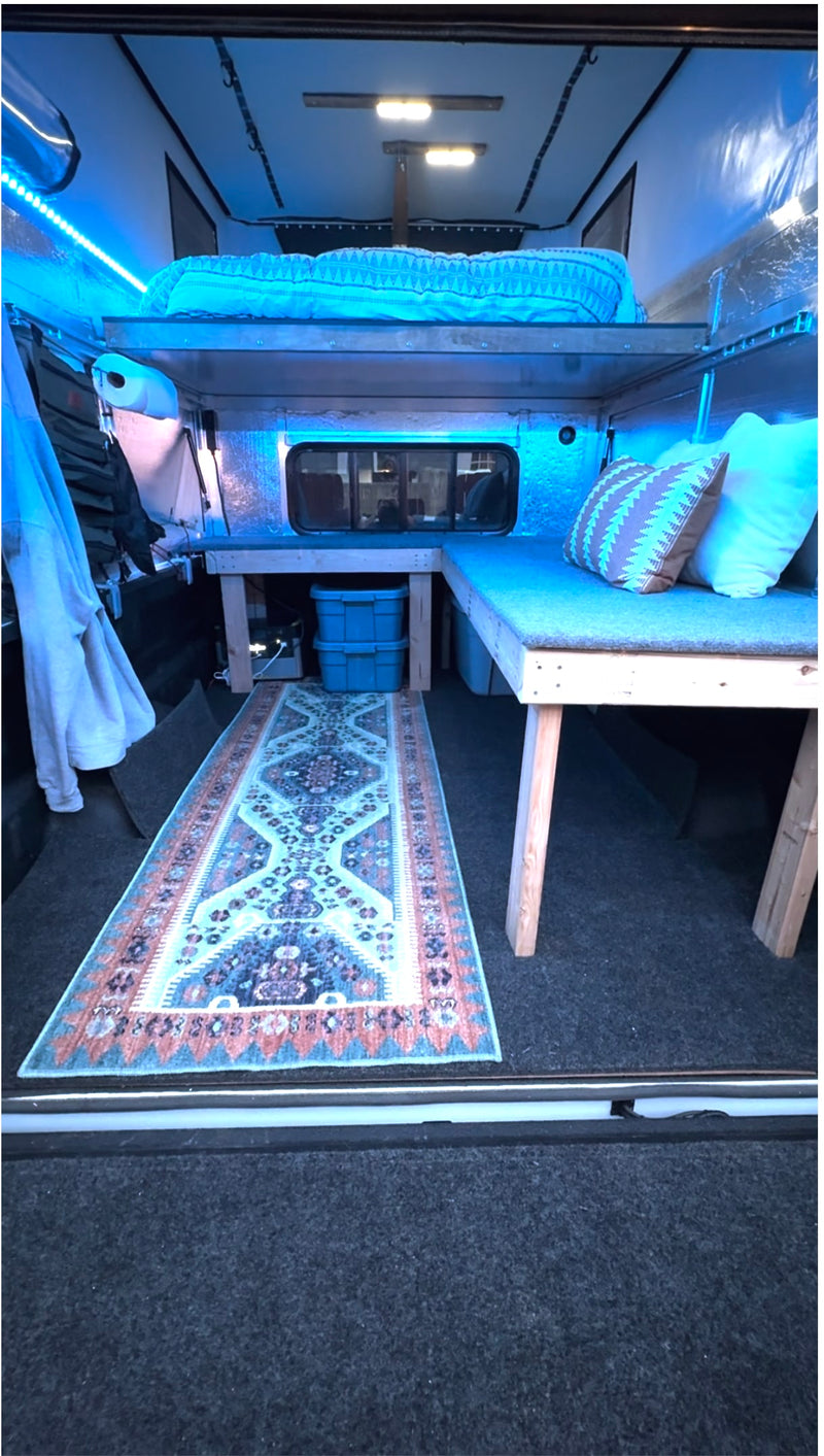  perfect for outdoor adventures.|Cozy RV rental: this camper interior features a raised bed — photo 1