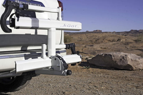 Vehicle's Kuat hitch bike rack, perfect for an rv rental outdoor adventure in rocky terrain.