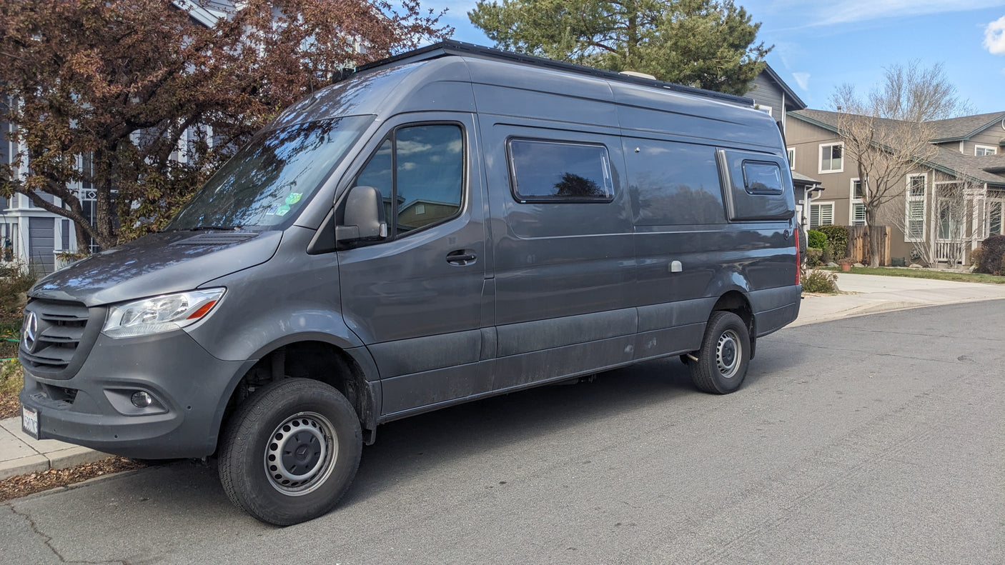 A versatile gray Mercedes Sprinter camper van, ready for your next RV rental journey, parked roadside.