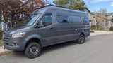 A versatile gray Mercedes Sprinter camper van, ready for your next RV rental journey, parked roadside.