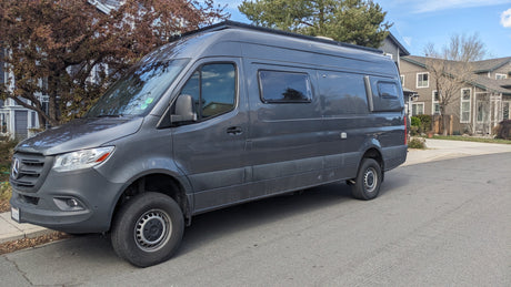 A versatile gray Mercedes Sprinter camper van, ready for your next RV rental journey, parked roadside.