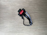 A black and red Husky headlamp, shown on a light-colored floor, crucial for RV rental night activities.