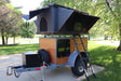 RV rental: Compact camper trailer with a deployed rooftop tent