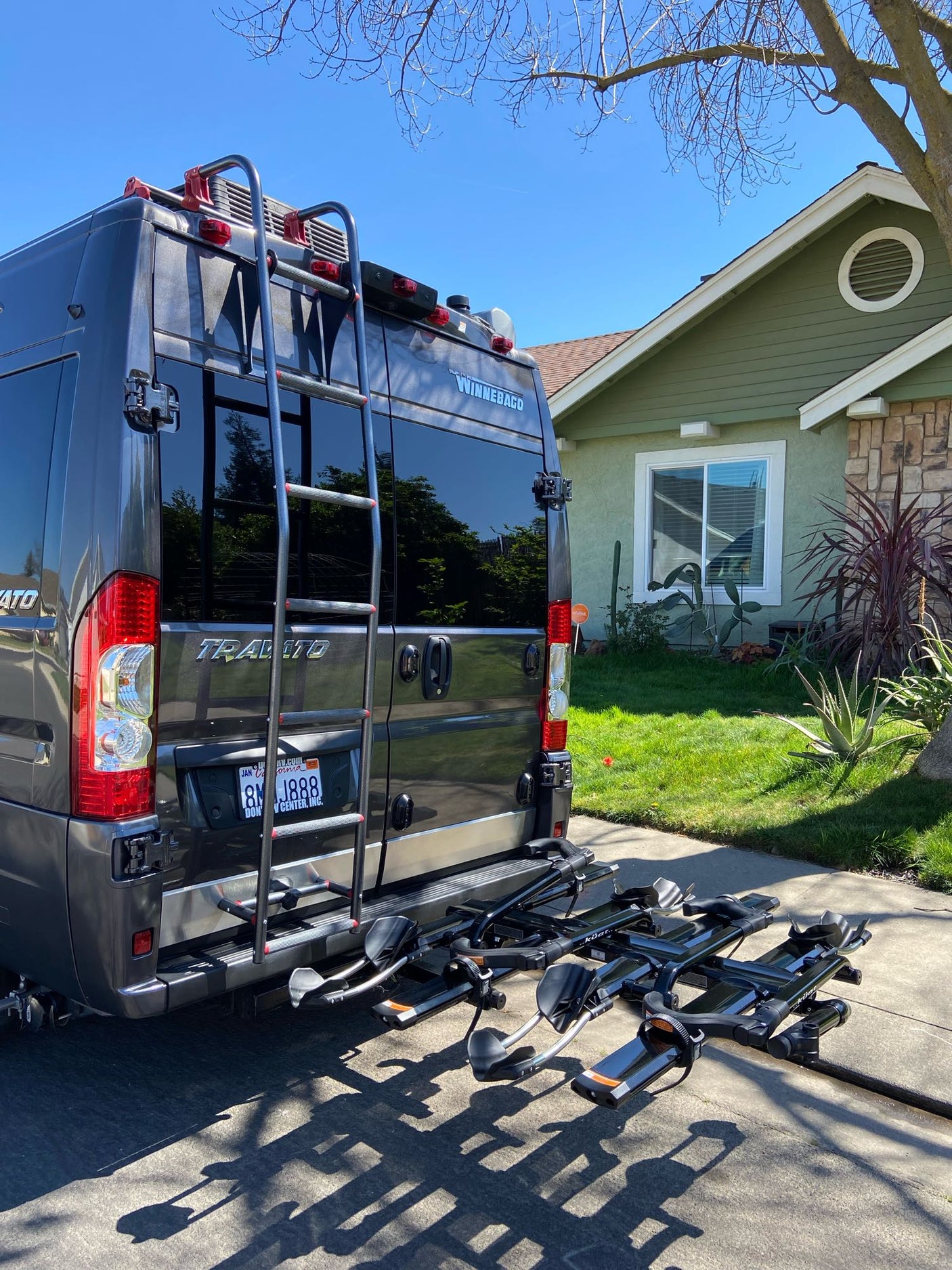 This Winnebago Travato RV rental, equipped with a bike rack, is ready for sunny day travels.