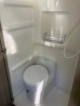 Inside an RV rental: a compact wet bath with integrated toilet and shower, ready for your travels.