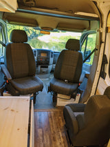 Spacious camper van interior, perfect for an RV rental adventure with front captain's chairs and scenic views.
