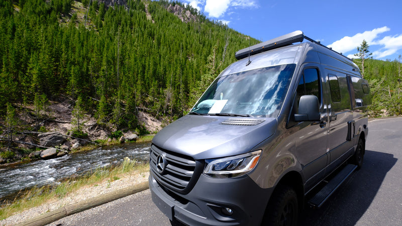  parked on asphalt with a lush green forest — photo 11
