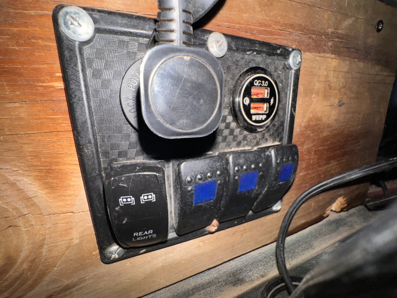 RV rental: custom panel with QC 3.0 USB charger, multiple switches for lights and accessories.