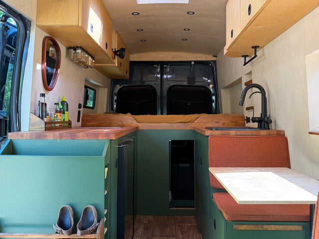 Experience a thoughtfully designed RV rental! This camper van interior features a custom kitchen