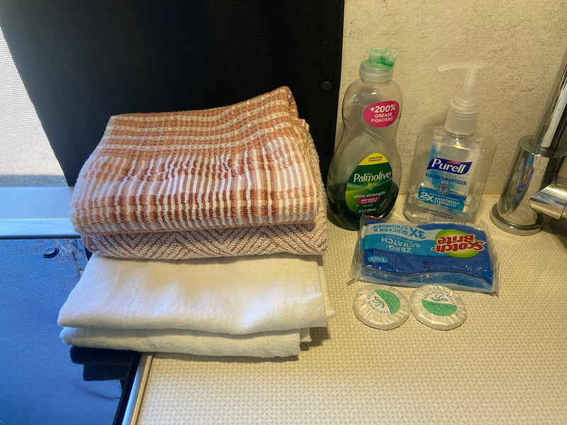 RV rental kitchen and bath essentials: towels, Palmolive soap, Purell, Scotch-Brite sponges, and Bergman Kelly soaps. — photo 19