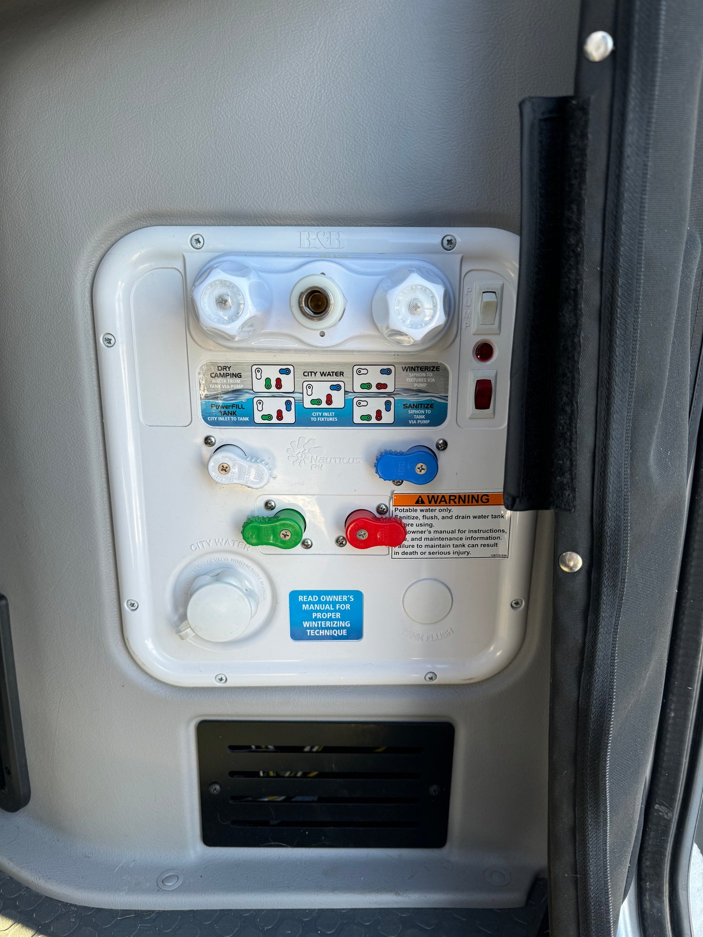 An RV rental's Nautilus P4 water system panel, showing controls for tank fill, city water, and winterizing.