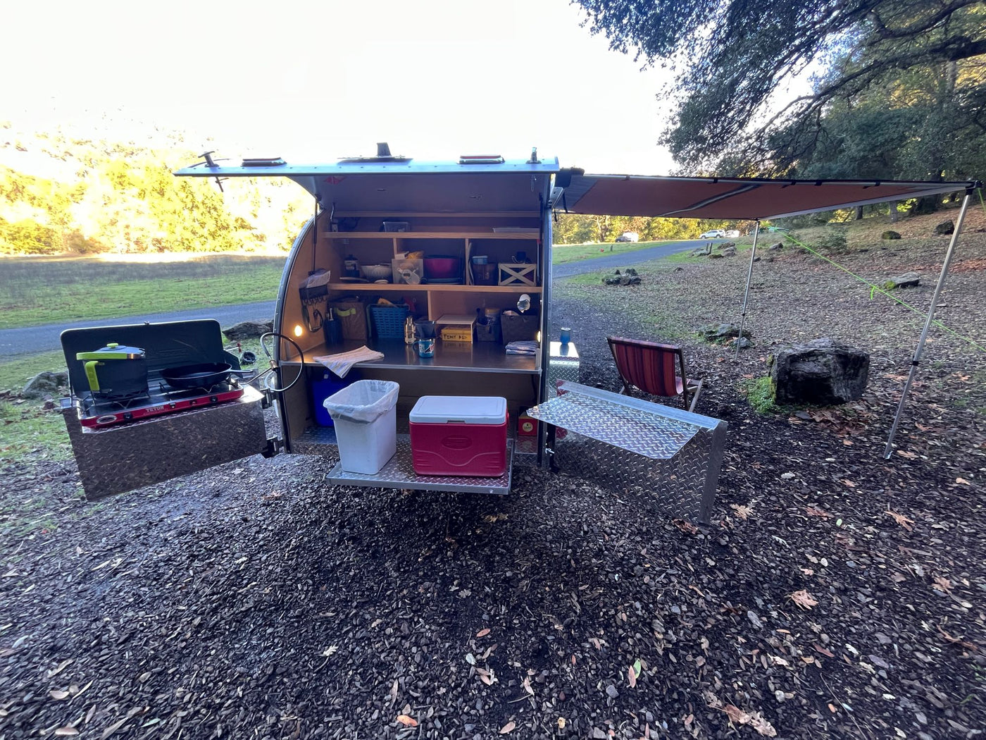  and ambient lights. Perfect outdoor adventure.|This RV rental teardrop trailer displays its organized galley kitchen — photo 10