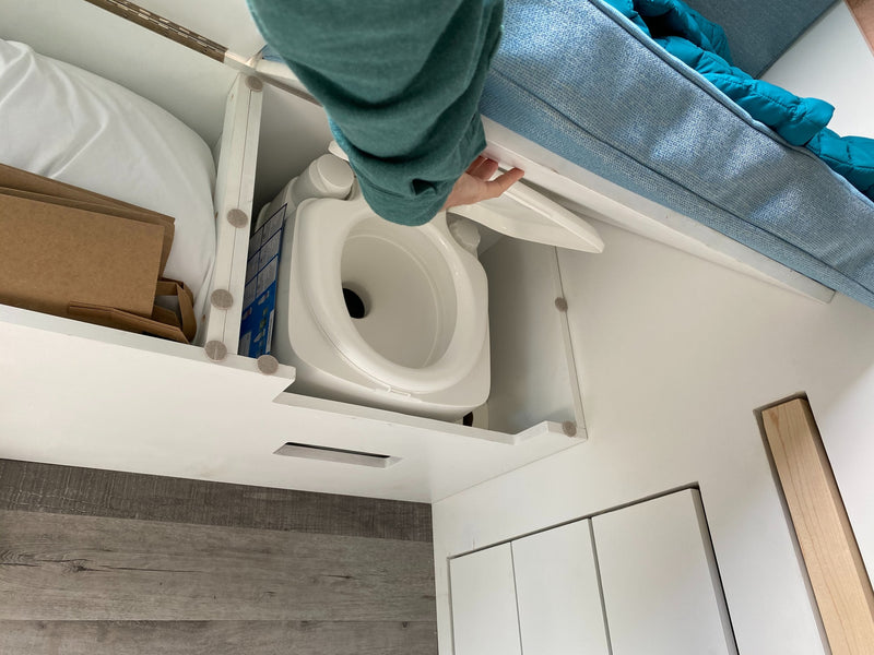  under-counter fridge/microwave & pegboard storage.|Inside an **rv rental**: a compact living space featuring a bed — photo 7
