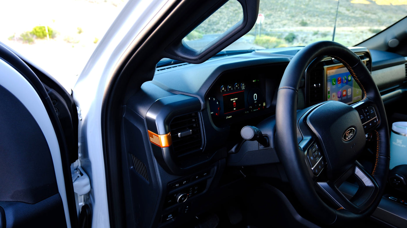 Inside a modern Ford truck, perfect for an rv rental adventure. Shows dashboard, digital gauges, and open driver's door. — photo 16