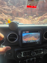 Off-road vehicle dashboard shows camera view of a desert trail. An adventure idea for your next rv rental getaway!