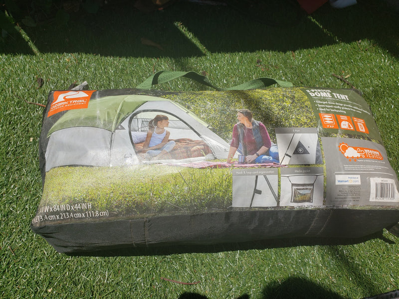 Packaged Ozark Trail 3-person dome tent on grass, ideal outdoor gear for camping trips, even with an RV rental. — photo 10