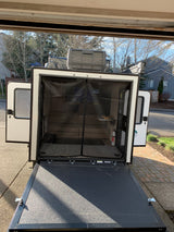 Explore this RV rental's unique features: a lowered rear ramp, screened interior, and rooftop AC, ideal for travel.