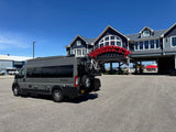 Gray Thor Sequence rv rental van with bikes, parked at a blue nautical-themed building featuring a unique red archway.