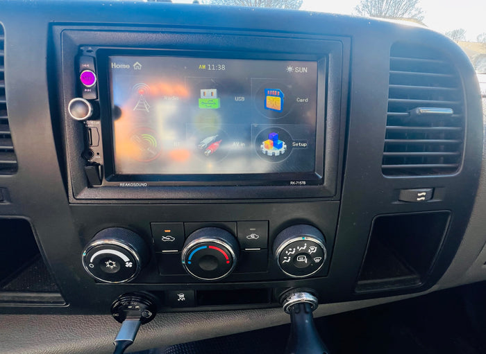 Inside an RV rental: Dashboard with Reakosound touchscreen stereo (AM 11:38, Radio, USB) & climate controls, ready for travel.